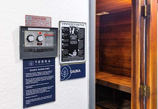 A wall with a sign that says "Caution To Avoid A Fire Risk On Conductive Materials" and another sign that says "Finnleo Sana".