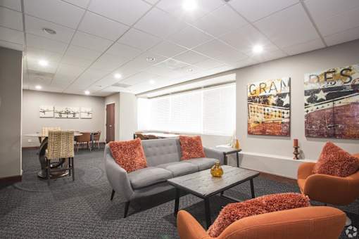 a living room with couches and chairs and a table