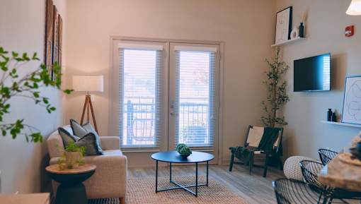 A living room with a couch, chair, and table.