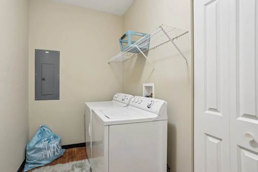 A small laundry room with a washer and dryer.