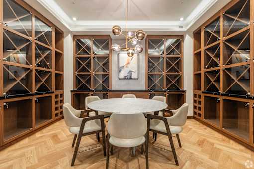 A dining room with a round table and chairs.