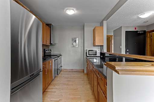 A kitchen with wooden cabinets and stainless steel appliances.