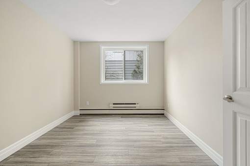 A room with a window and a bench.