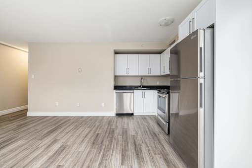 A kitchen with a refrigerator, stove, and oven.