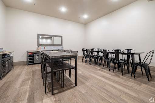 A dining room with a table and chairs.