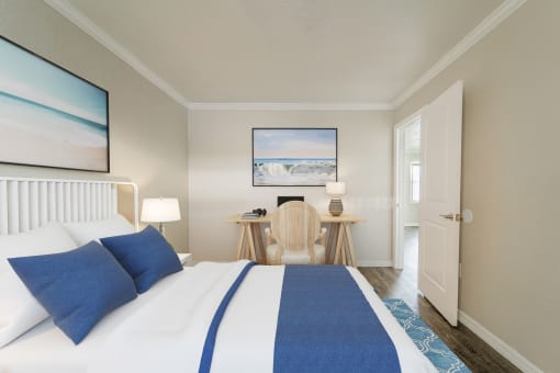 a bedroom with a bed and a desk  at North Washington Apartments
