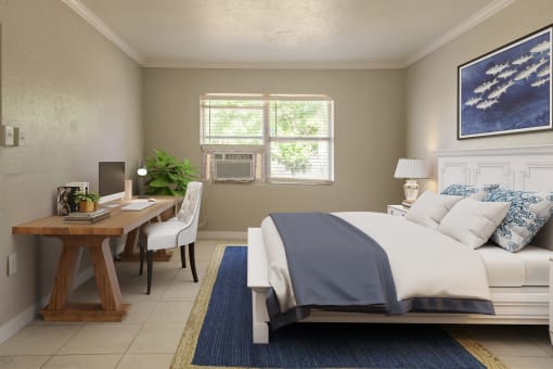a bedroom with a bed and a desk with a computer at North Washington Apartments