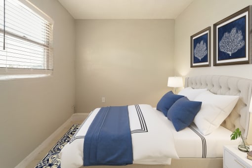 a bedroom with a bed and two paintings on the wall  at North Washington Apartments
