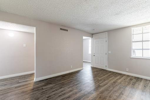 A room with wooden floors and a white door.