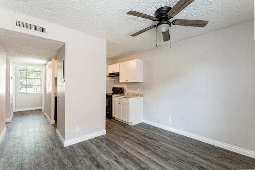 A room with a ceiling fan and a cabinet.