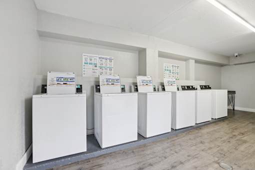 A series of white boxes are lined up in a room.