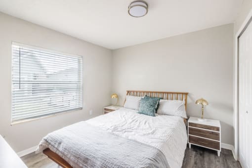 Bedroom with a bed and a window_Rolling Hills Apartments