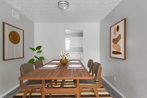A dining room with a wooden table and chairs.