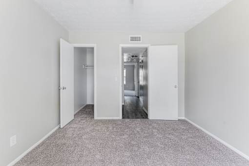 A room with two open doors leading to another room.