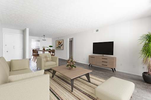 A living room with a couch, chairs, and a coffee table.