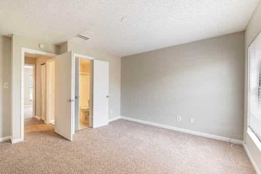 A room with a carpeted floor and a white ceiling.