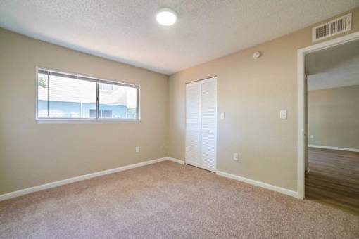 A room with a window and a door.