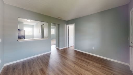 a living area with hardwood flooring and grey walls