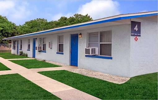 A white building with blue trim and a sign that says 4.
