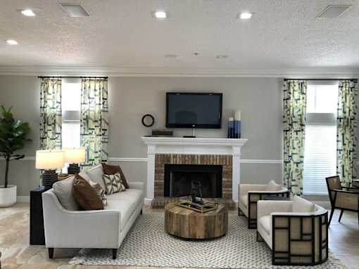 A living room with a fireplace and a television.