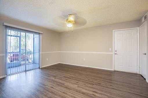 A room with a sliding glass door and a white door.