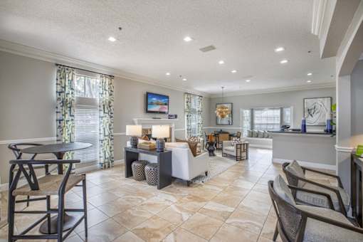 A well-lit living room with a dining table and chairs.