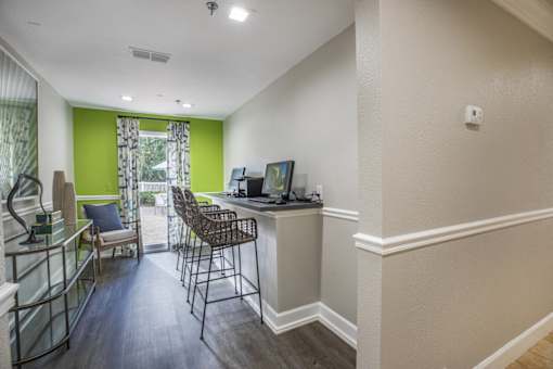 A room with a desk and chairs.