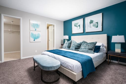 a bedroom with a bed and a blue wall and a closet at Fairways of Inverrary, Lauderhill, 33319