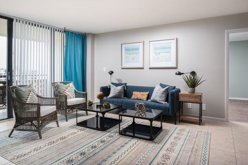 a living room with a blue couch and two chairs at Fairways of Inverrary, Lauderhill, Florida