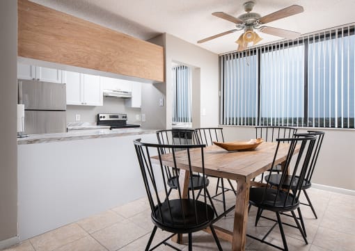 a kitchen and dining room with a wooden table and chairs at Fairways of Inverrary, Lauderhill, 33319