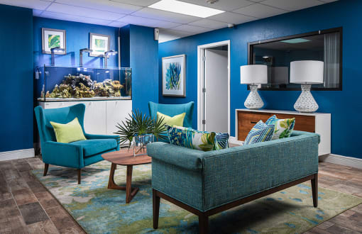 a living room with blue chairs and a fish tank at Fairways of Inverrary, Lauderhill, 33319