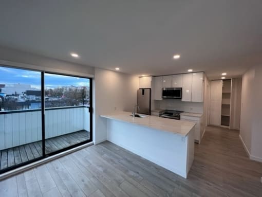 a kitchen and living room with a large window