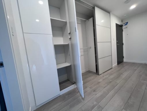 a walk in wardrobe in a bedroom