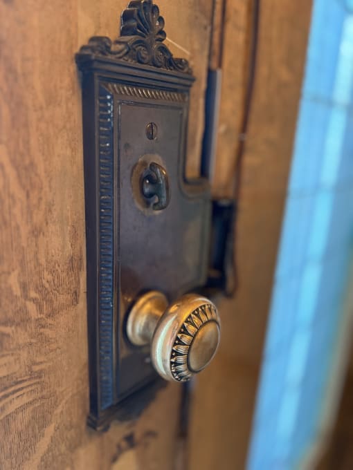 a close up of a door knob on a wooden door