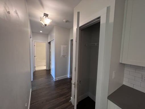 a bedroom with a medium sized closet and a door that is open