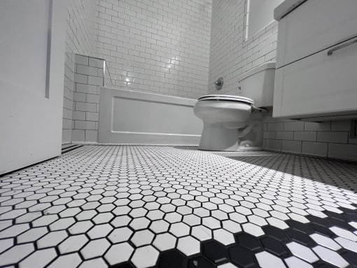 a white toilet sitting next to a bath tub