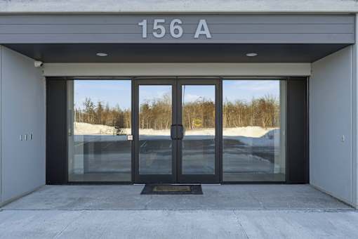 The entrance to a building with the number 156 A on the top.