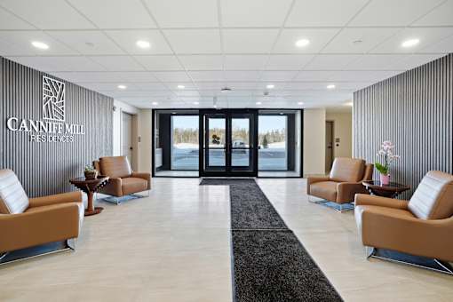 A reception area with chairs and a sign that says Cannife Mill.