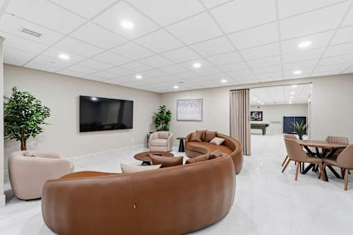 A modern living room with a brown sofa and a television.