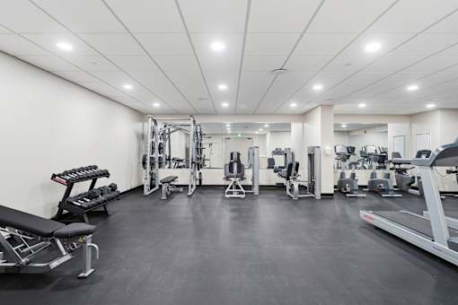 A spacious gym with various exercise equipment.