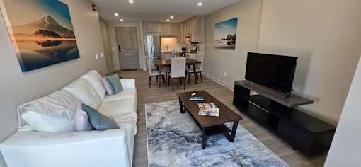A living room with a white couch and a television.