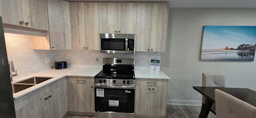 A kitchen with a stove top oven and microwave above it.