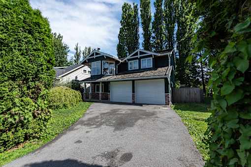 a house with a large driveway in front of it