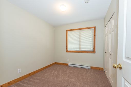 a bedroom with a window and a door