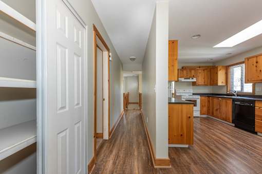 a bedroom with a large window next to a kitchen