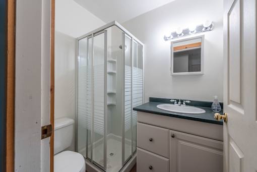 a bathroom with a toilet sink and shower