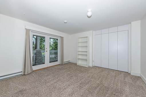 a bedroom with a door to a balcony