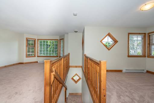 a large living room with a staircase leading up to the second floor