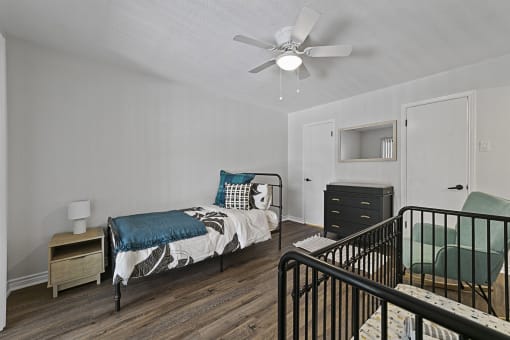 Bedroom with cozy bed and light a bedroom with a bed and a ceiling fan at Lakeside Apartments, Dallas, TX