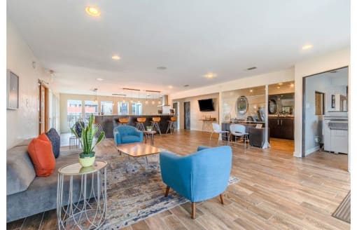 a living room with couches and chairs and a kitchen at Cityscape, Dallas, TX